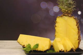 Pineapple with slice and bokeh